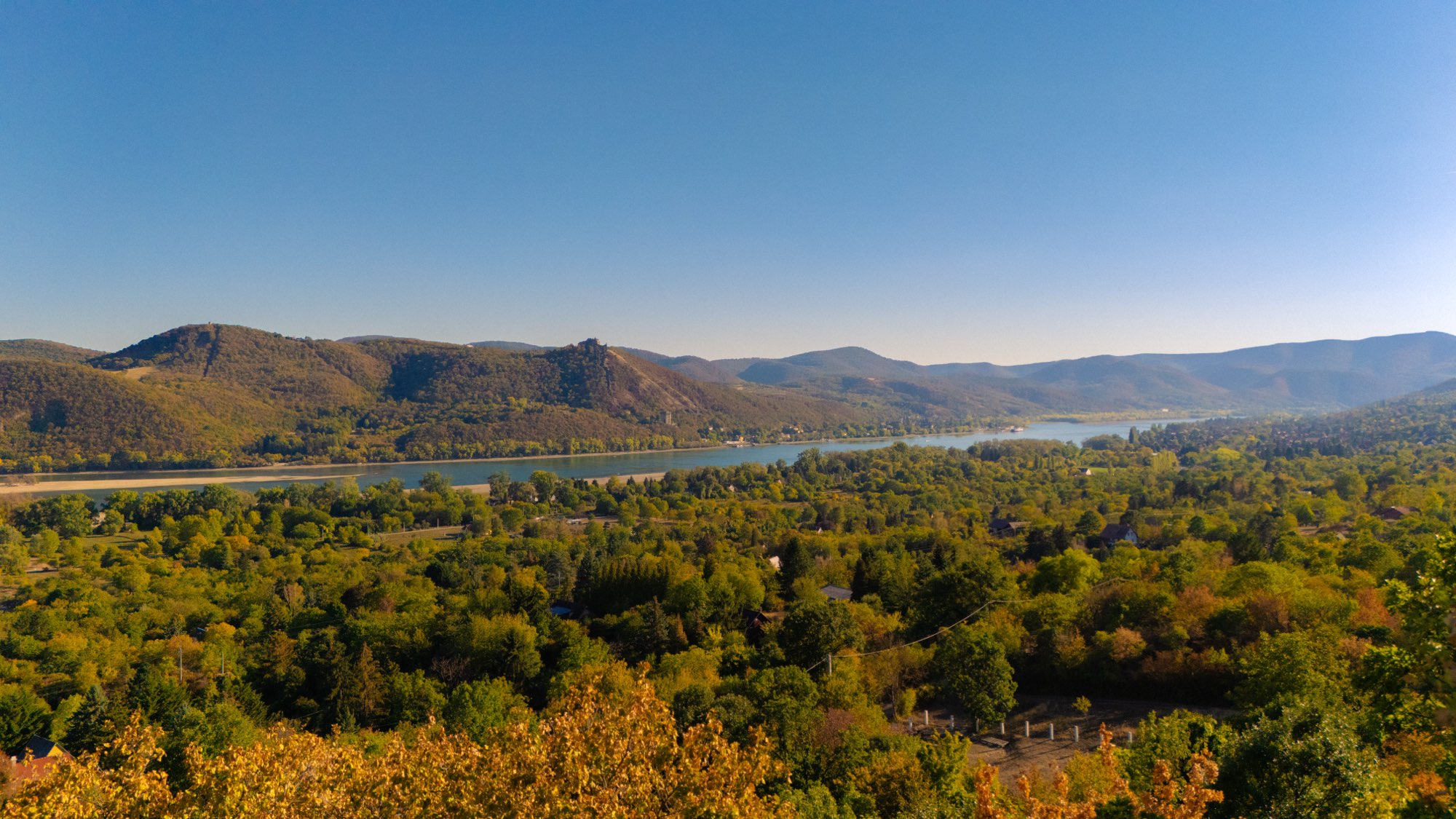 Aerial view over the wooded hills above Kismaros with the Danube valley beyond