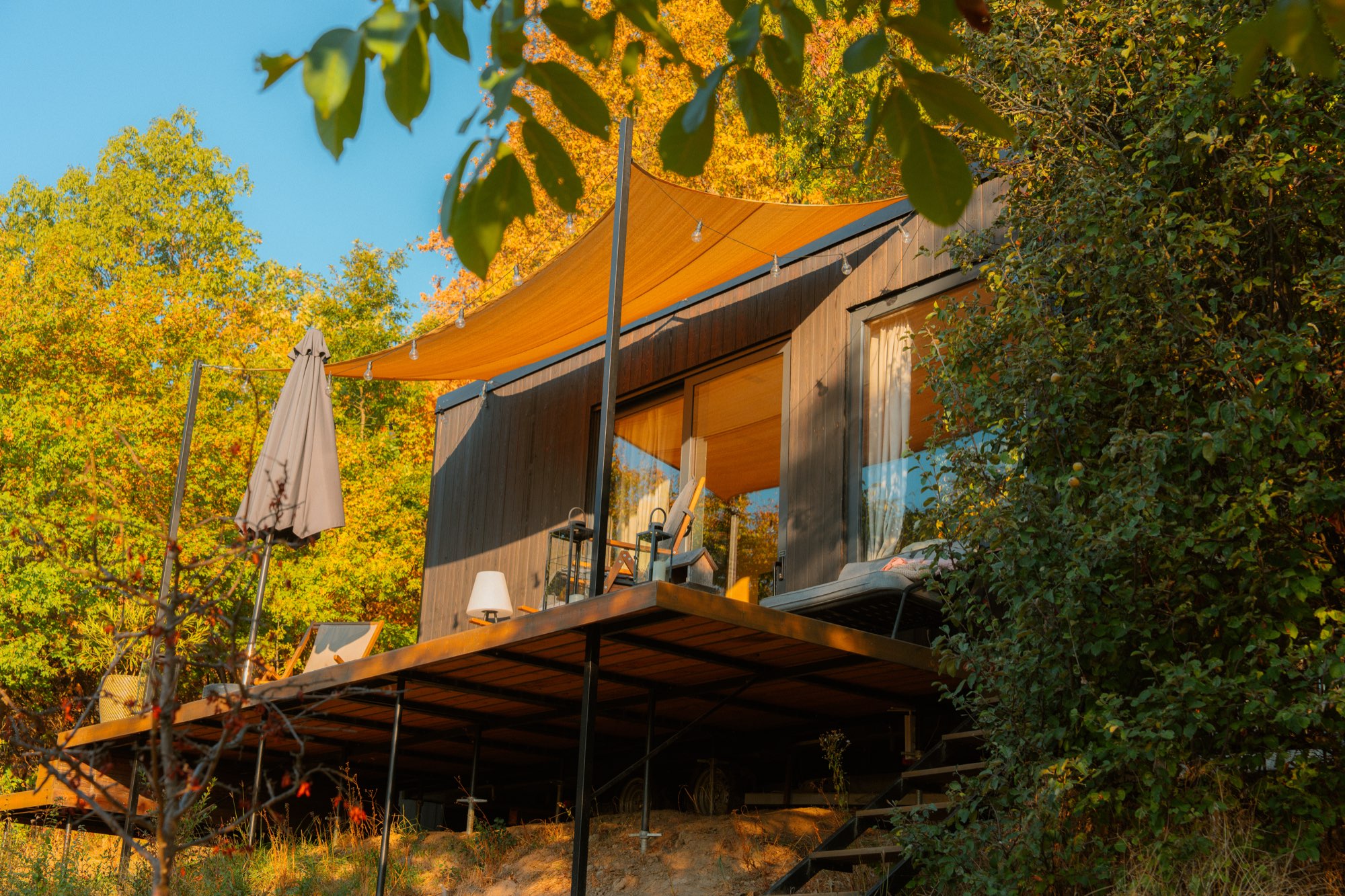 The cabin from below, its deck cantilevered out over the slope