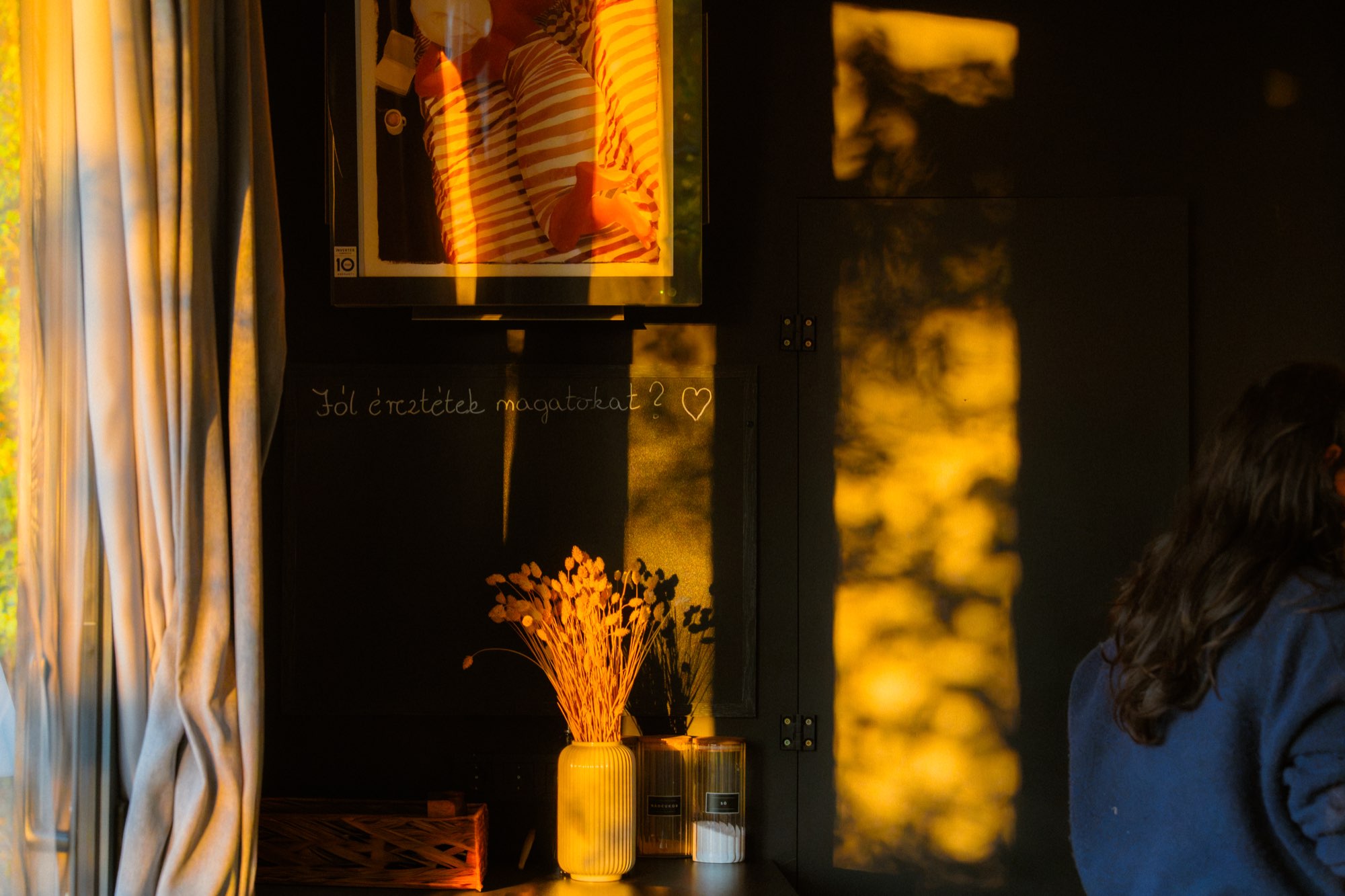 Dried flowers on a shelf in warm low interior light