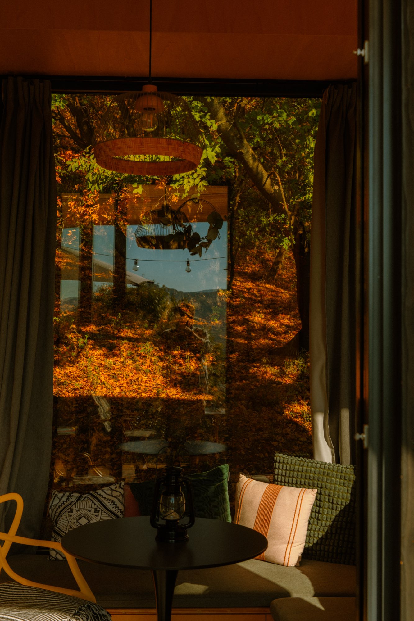 Looking out from inside the cabin to the lantern-lit deck
